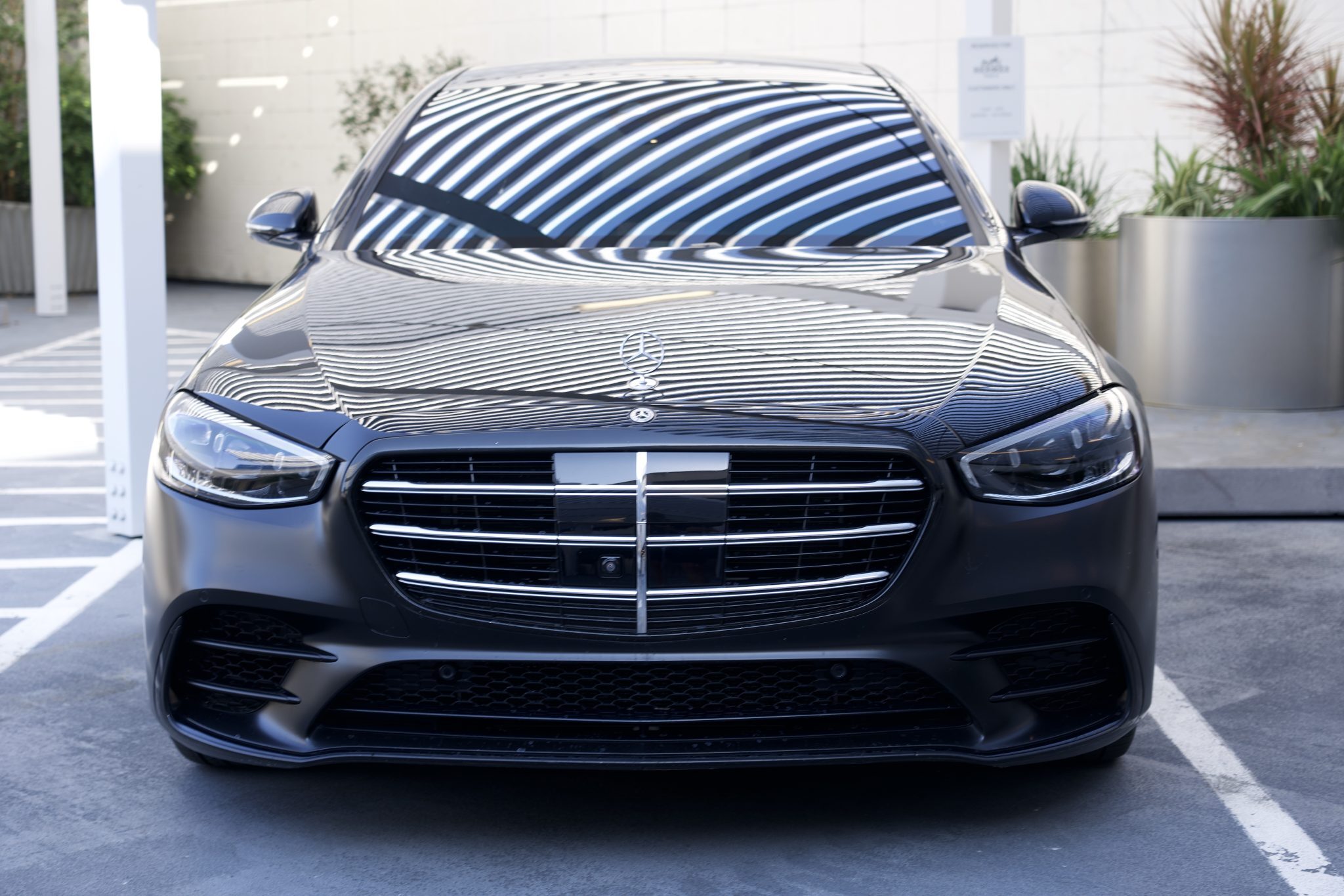 Close-up of the Mercedes-Benz S580 rental in Houston, featuring its striking grille and elegant headlights.