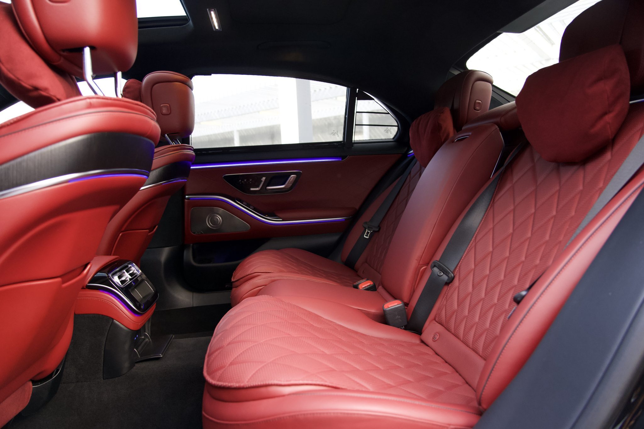 Rear seating area of the Mercedes-Benz S580 luxury sedan, offering reclining seats and massage features for Houston rentals.