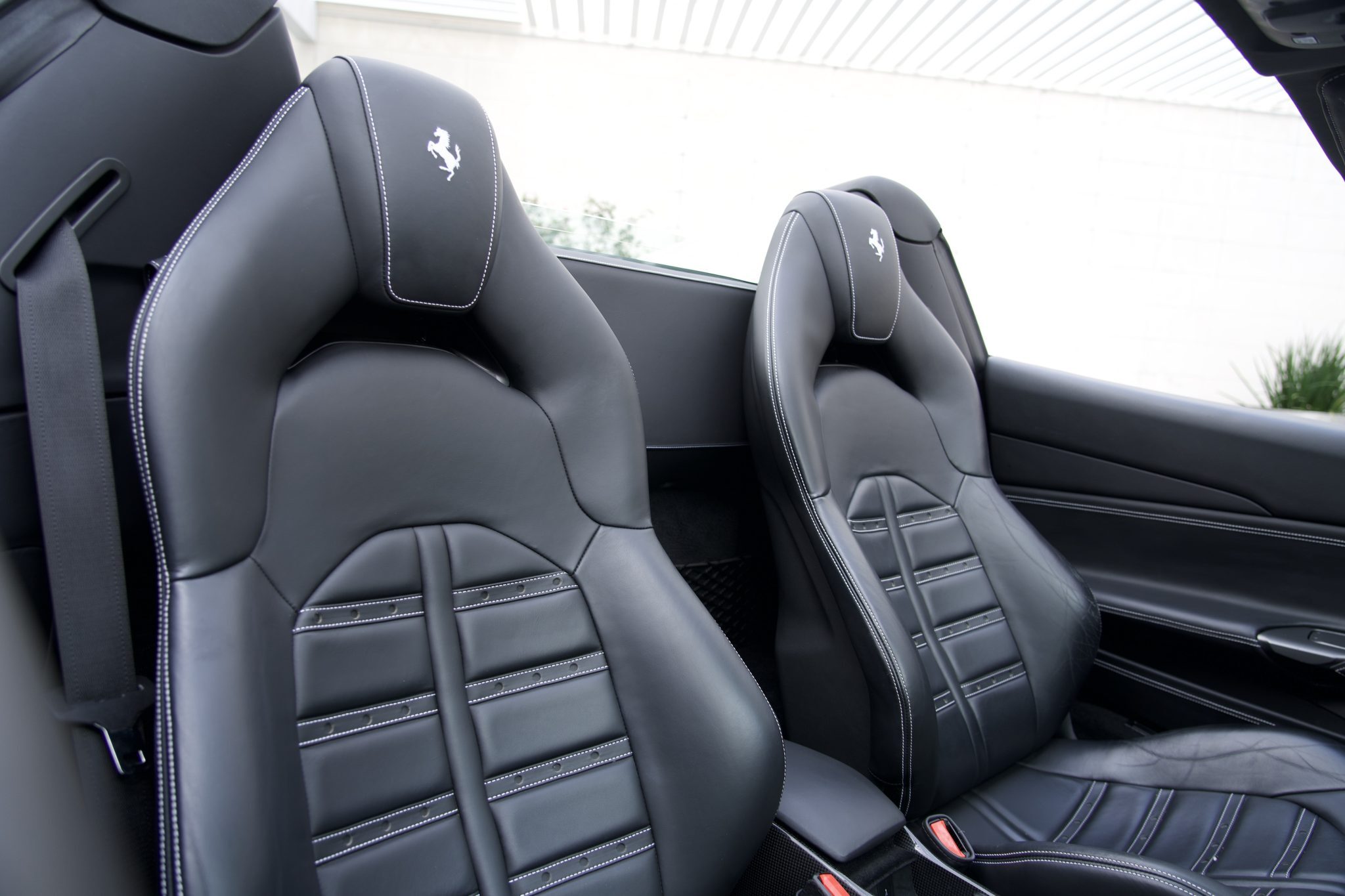 Leather seats of the Ferrari 488 Spider, designed for luxury and comfort, available for exotic rentals in Houston.
