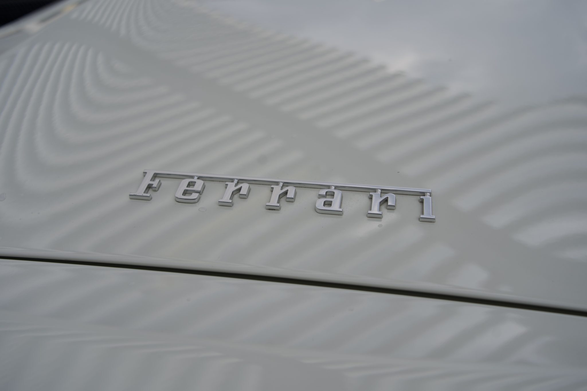 Close-up of the Ferrari logo on the rear of the 488 Spider, representing exotic car rentals in Houston.