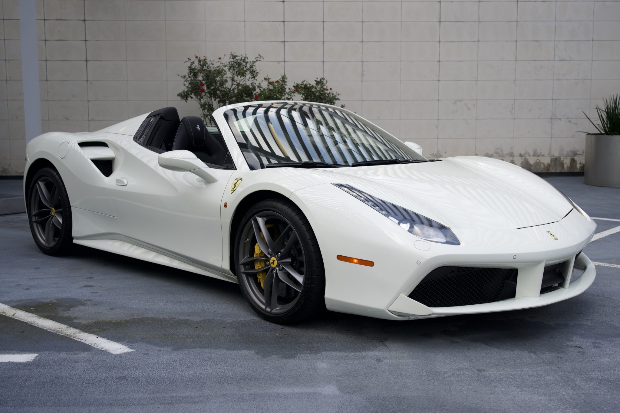 Ferrari 488 Spider in white, showcasing its sleek and powerful exterior for luxury rentals in Houston.