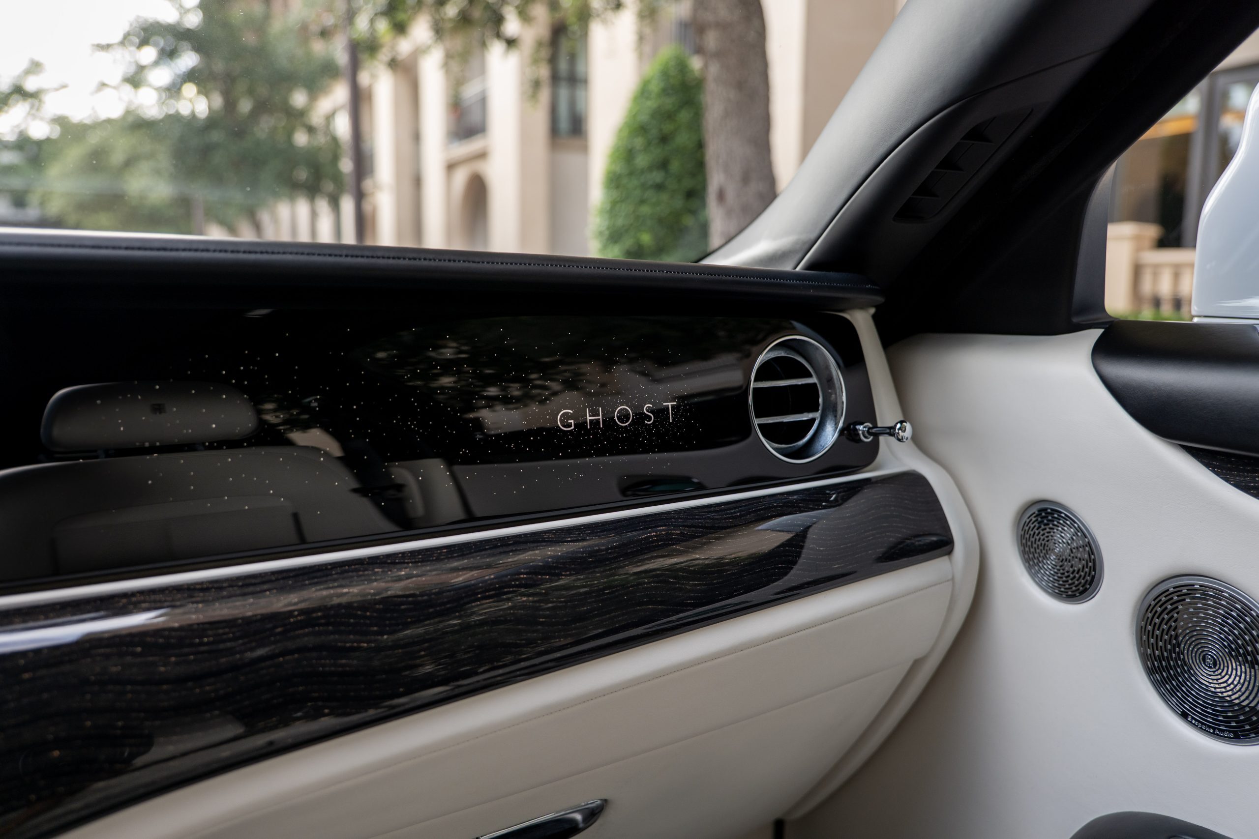 Rolls Royce Ghost illuminated “GHOST” dash, air vent, and Bespoke Audio speakers blend into elegant white and black interior.