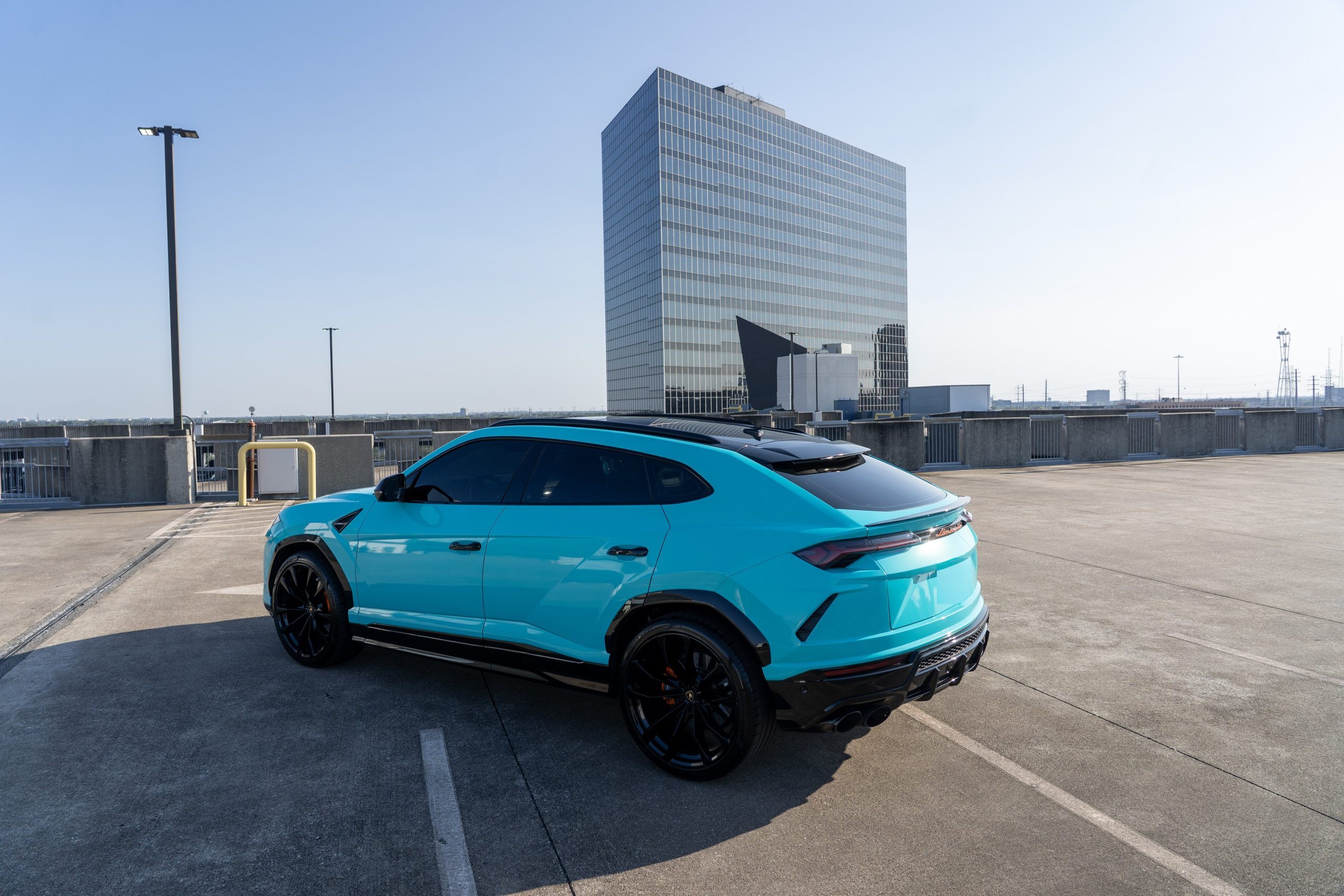 Turquoise Urus side profile Houston luxury rental