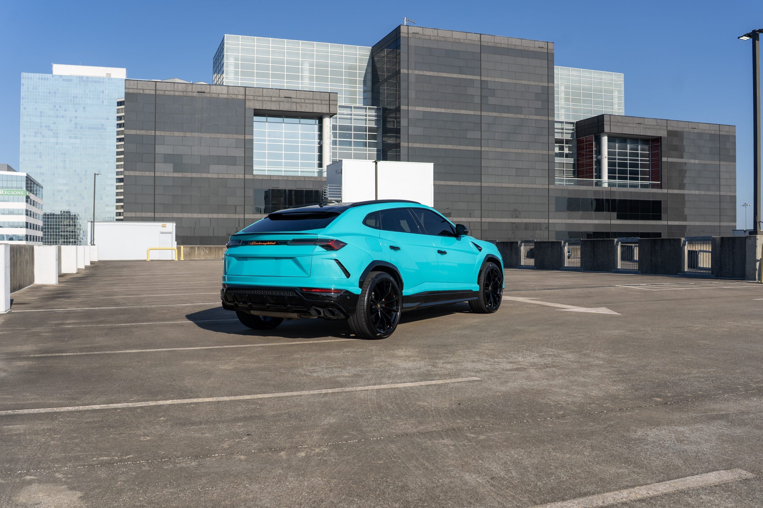 Turquoise Lamborghini Urus side view Houston rental