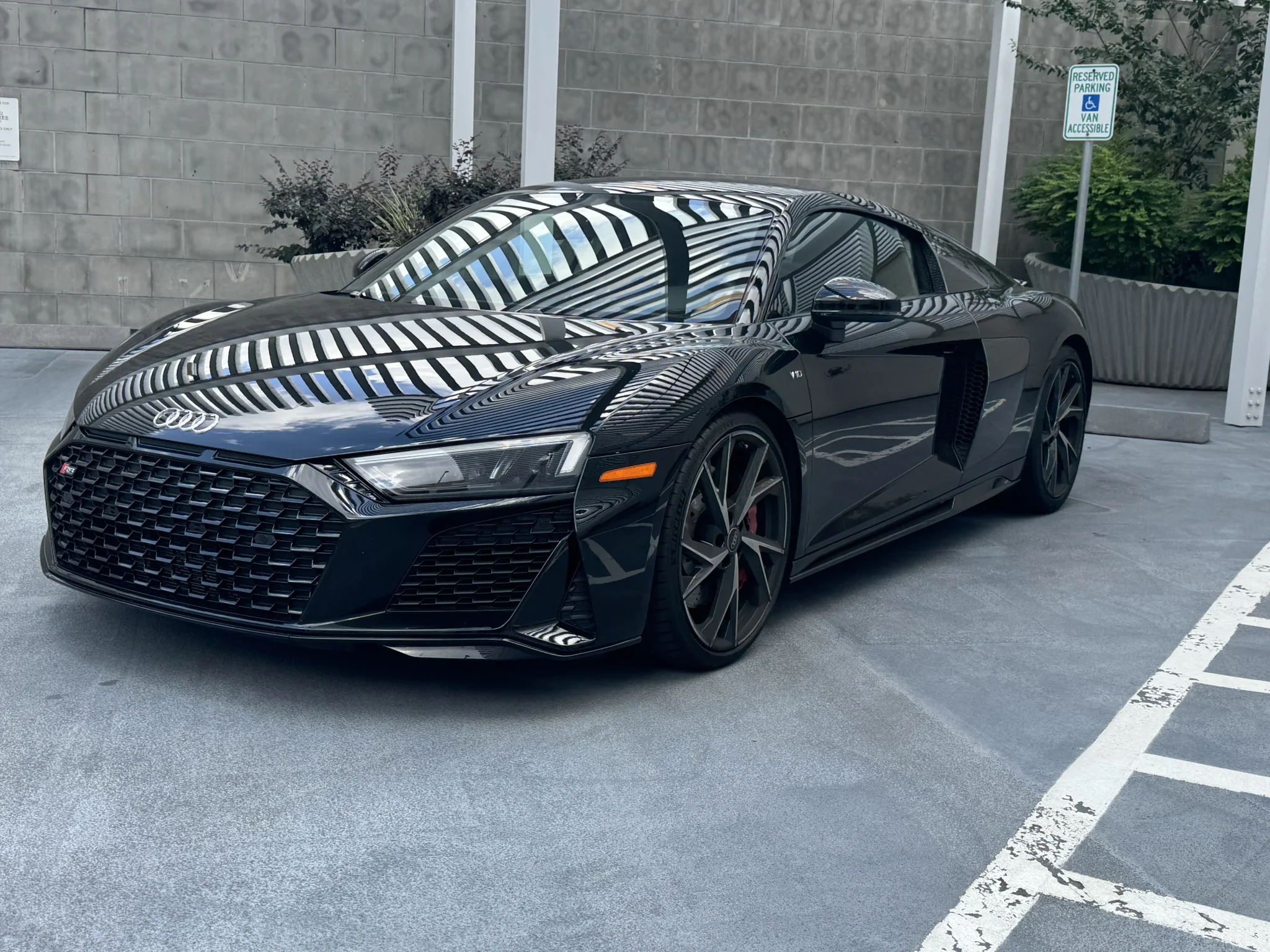 Audi R8 luxury sports car in black, showcasing a bold and aerodynamic front angle for Houston rentals.