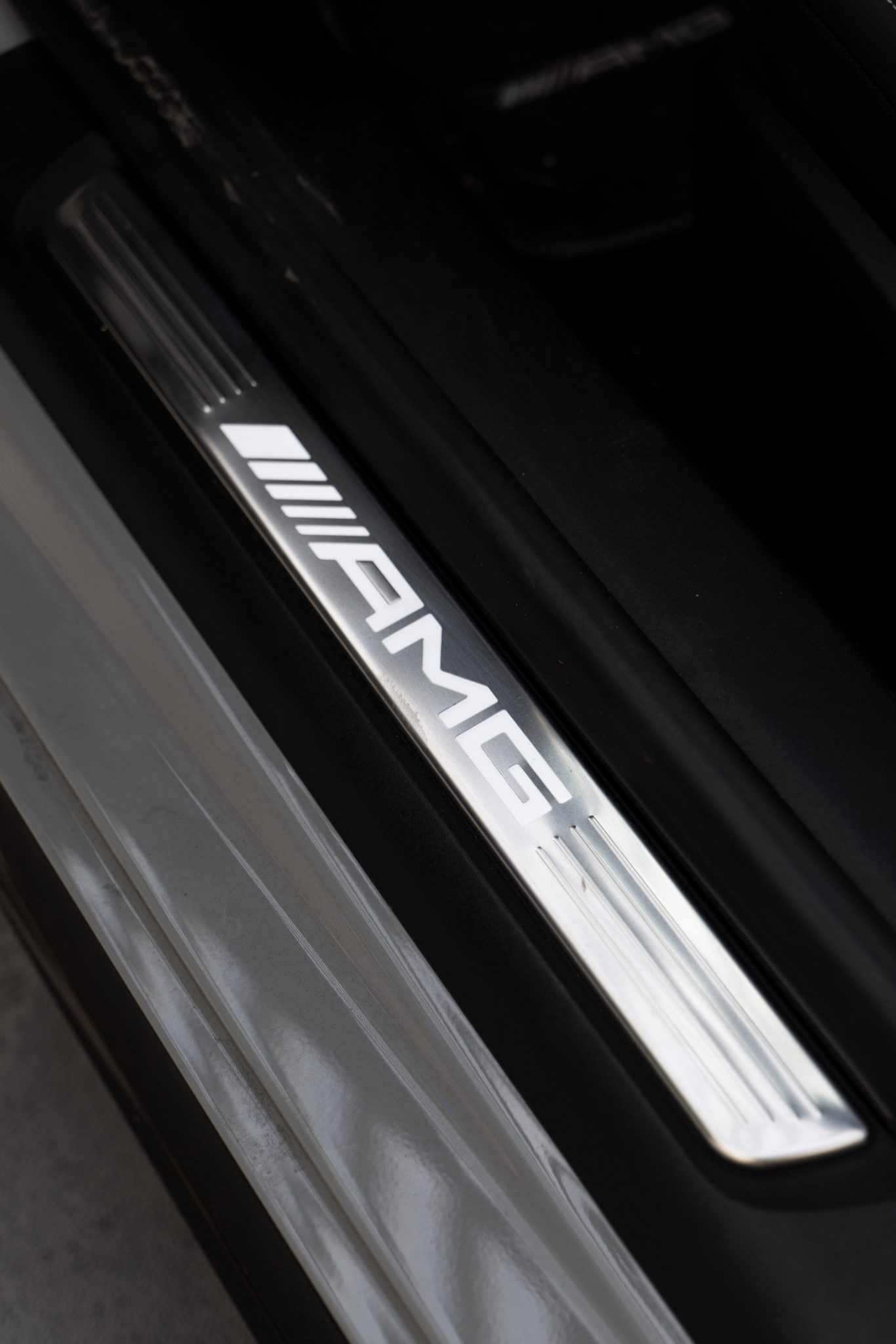 Polished AMG chrome door sill plate on Mercedes-Benz SL63 AMG.