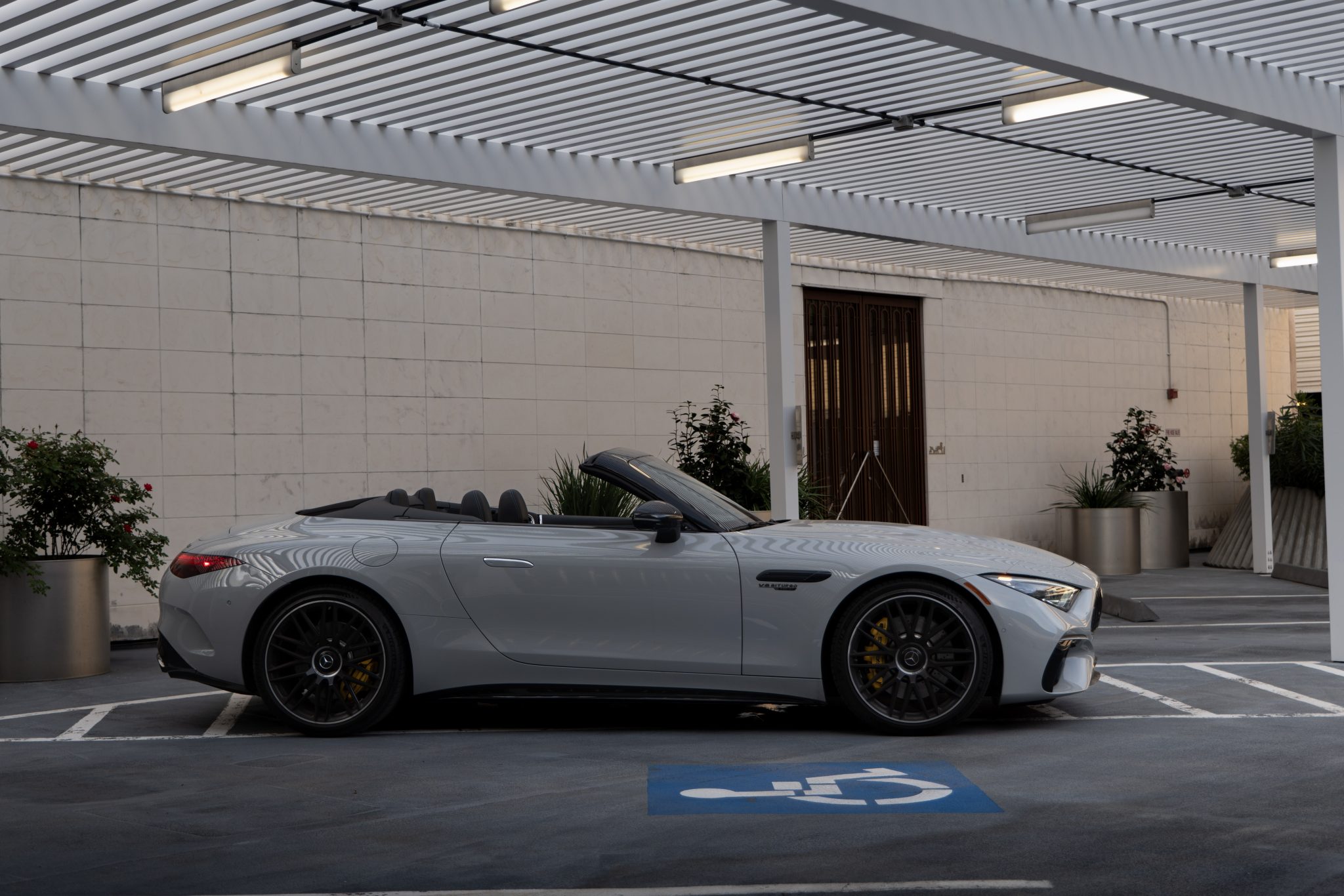Side view of Mercedes SL63 AMG coupe emphasizing coupe lines and AMG wheels in Houston