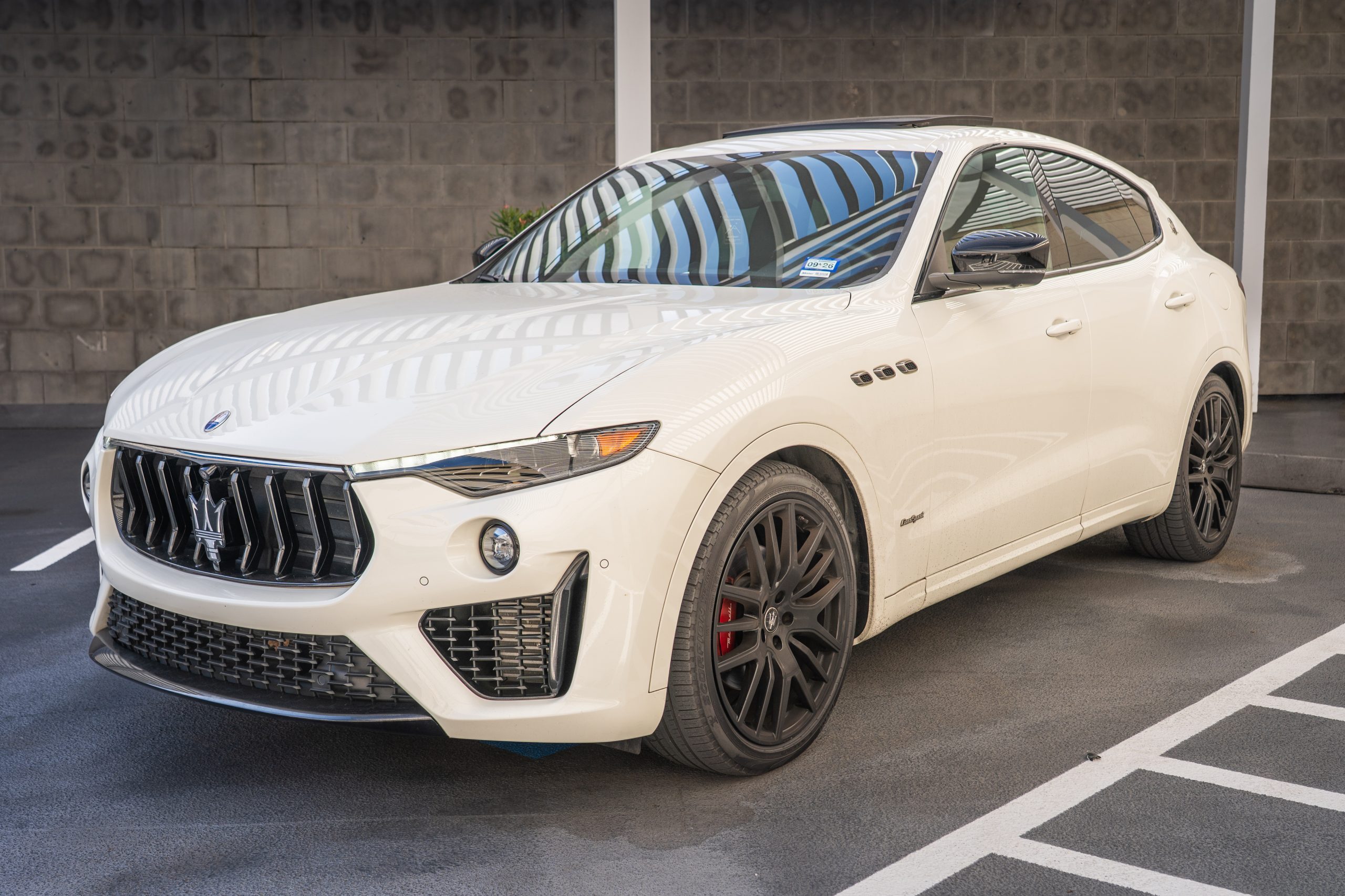 White Maserati Levante angled front exterior with black rims and side vents
